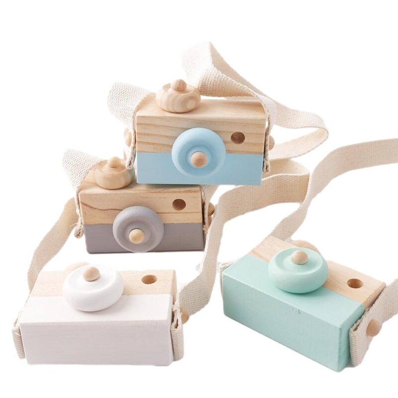 Wooden baby cameras blue, grey, white, and green stacked over a white background