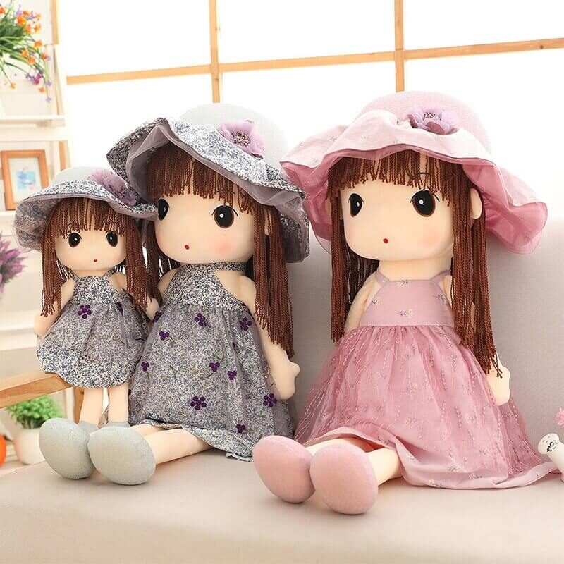 Blue and pink race day sun hat rag doll friends sat together on the couch