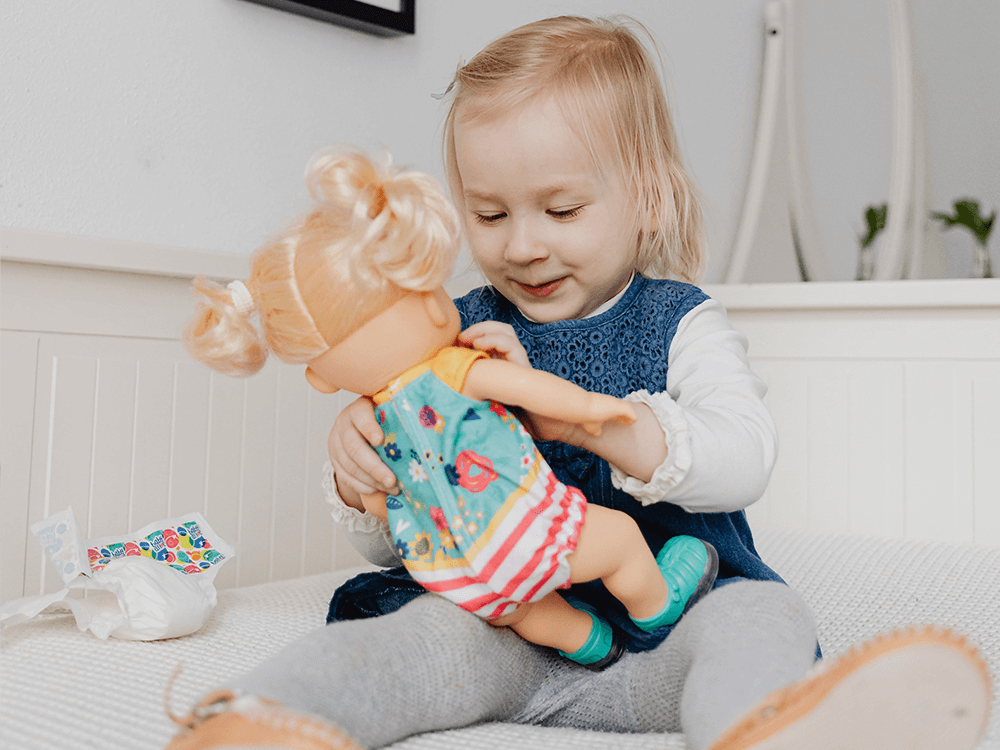 Child playing with doll