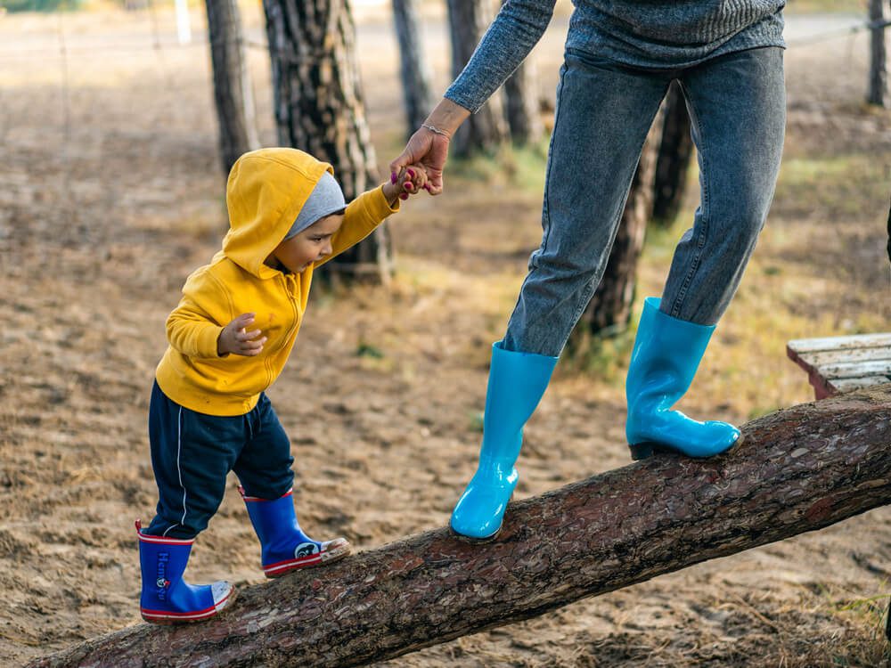 Child walking on a log