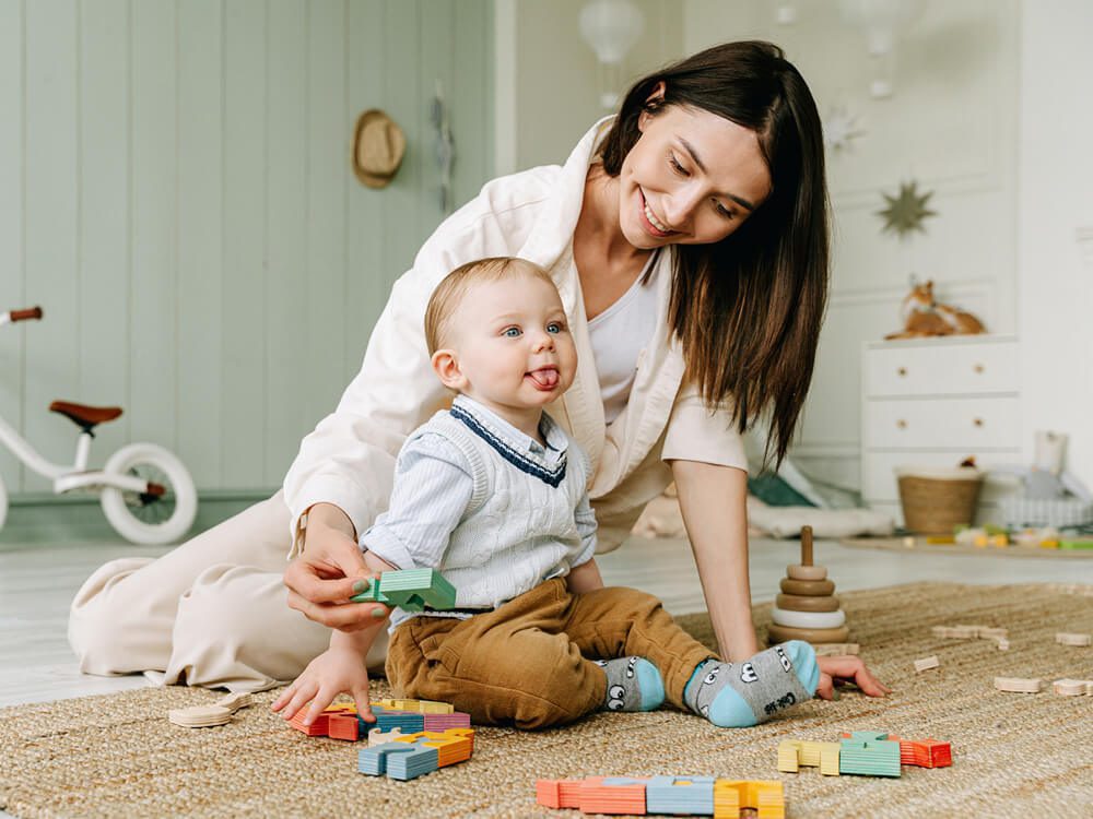 Mum and toddler playing with blocks